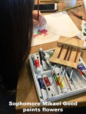 Student painting flowers