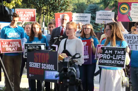 Bates_studentsstandbehindspeaker_courtesyofMirandaBracken